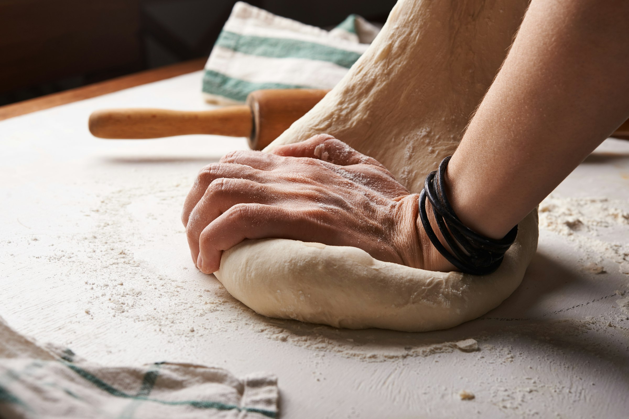 Baker kneading dough by hand